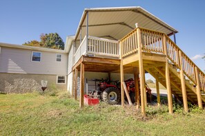 A two-story building with a wooden deck and a covered porch. - Rustic Whitwell Home w/ Grill, Near State Parks! (Whitwell)