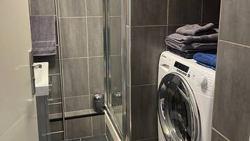 Shower, towels, soap, toilet paper