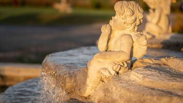 A stone sculpture of a seated figure with a detailed carving.