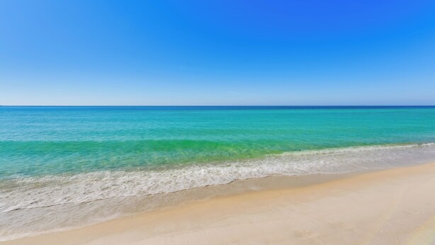 A beach with clear turquoise water and a sandy shore. - Steps to Shore: PCB Condo w/ Pool Access + Views! (Panama City Beach)