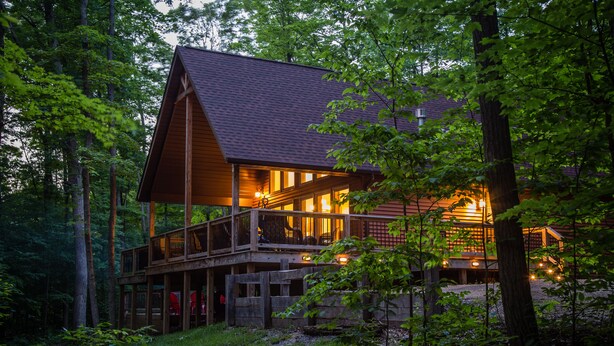 A cabin with a wooden exterior, a balcony, and a porch area. - Pine Lane is your cozy, pet-friendly escape -w/ hot tub, fire pit, & peaceful vibes near Mohican (Butler)