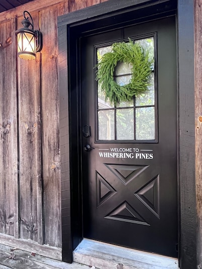 Cozy 2BR/2BA cabin tucked in the trees with hot tub, fire pit, covered deck, and fast WiFi.