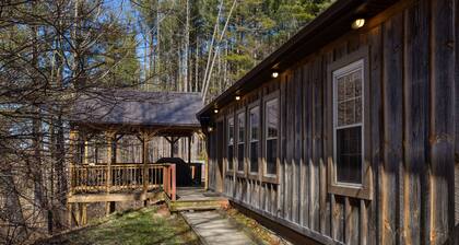 Cozy 2BR/2BA cabin tucked in the trees with hot tub, fire pit, covered deck, and fast WiFi.