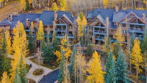 A lodge with multiple buildings, surrounded by a forest with autumn-colored trees. - Spacious 3BR ski-in/out Beaver Creek condo with valley views. (Beaver Creek)