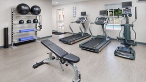 A gym with treadmills, a bench, and exercise balls. - Welcome to The Courtyard at The Villages!
A Cozy Floridian Escape. All Luxuries! (Wildwood)