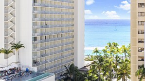 A high-rise hotel with multiple balconies overlooking a beach. - High Floor 2BR/2BA+Den 4beds Partial Ocean View + 1 Parking 2 min from the Beach (Honolulu)