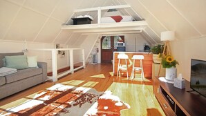 Ein Loft-Wohnraum mit Sofa, Couchtisch, Fernseher, Bar und einer Treppe zu einer erhöhten Ebene.