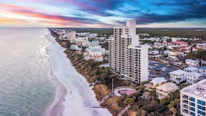 An aerial view of a coastal town with a beachfront, high-rise buildings, and a mix of residential and commercial structures. - One Seagrove Place 1103 (Santa Rosa Beach)