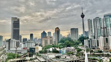 A cityscape with a prominent tower and various buildings, including a hotel with a sign.