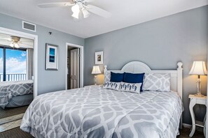 Relax in this inviting bedroom with a large bed, bedside lamps, and a ceiling fan.