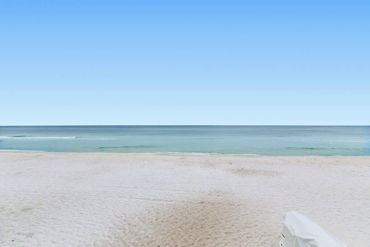 A beach with clear skies and calm waters.