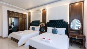 A hotel room with two beds, a large mirror, a vanity with a mirror, and a wardrobe. - Royal Hotel - Sai Dong - Long Biên (Hanoi)