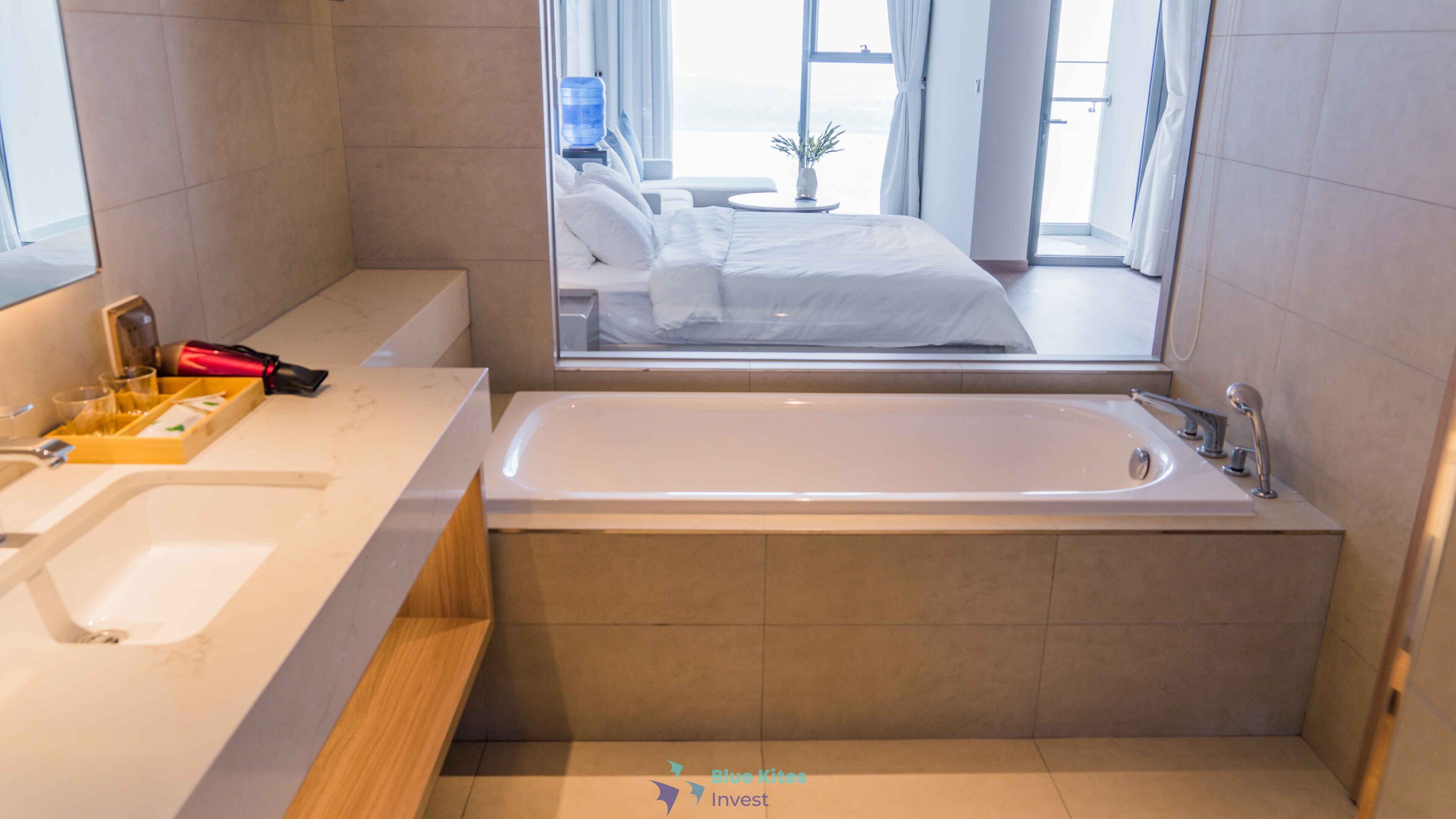 A modern bathroom with a bathtub, a sink, and a vanity.