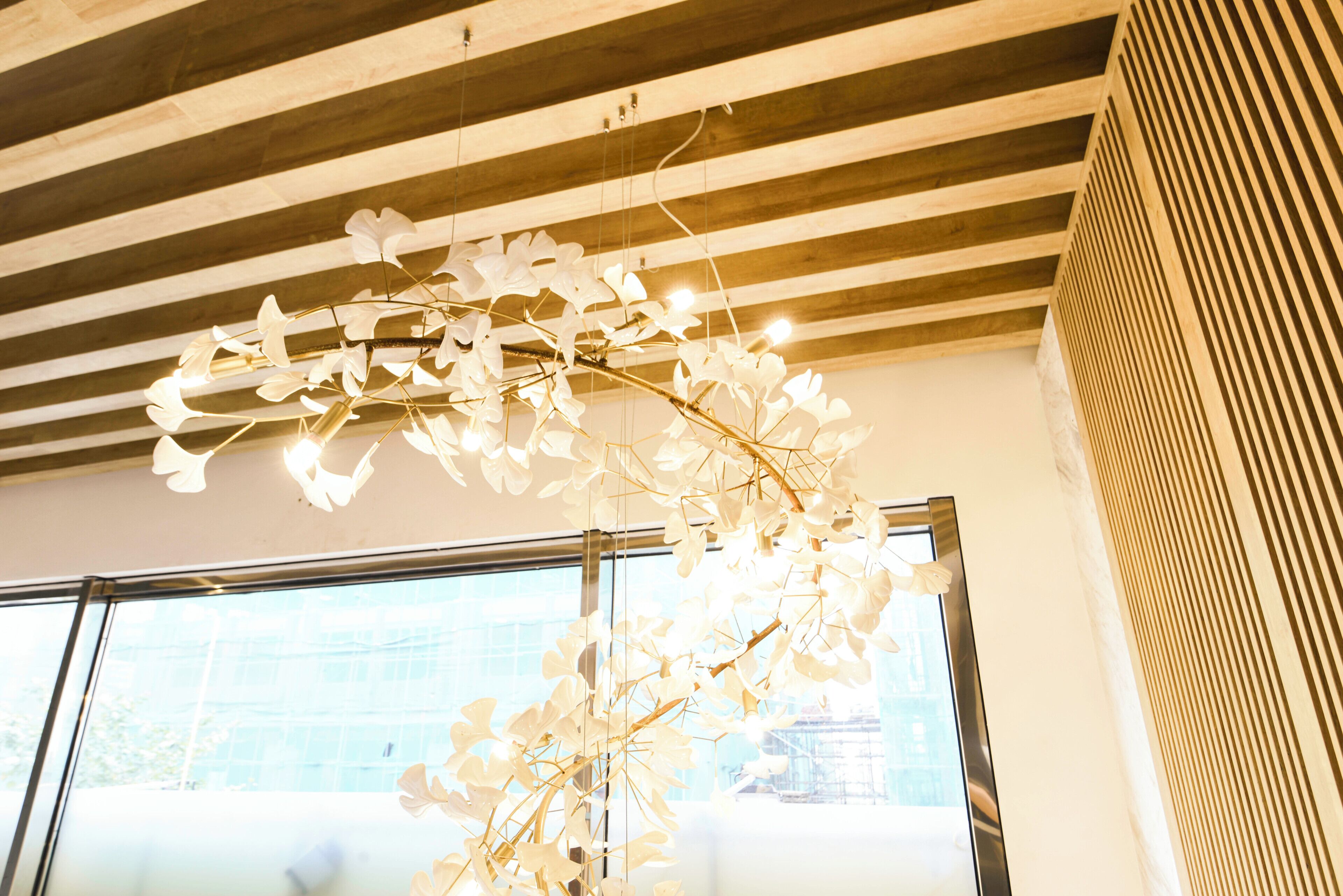 Un plafond avec des poutres en bois et un luminaire suspendu.