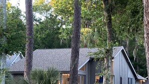 A cabin with a sloped roof, large windows, and a deck area. - Muirfield RANCH/ On #2 Golf Links / Pool / Walk to HARBOUR TOWN/ 4 Bikes / Pet (Hilton Head Island)