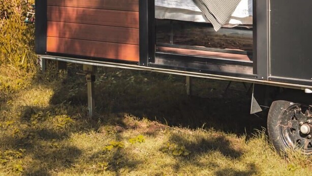A small, modern cabin with a bed and a window. - Mirror Reflections 1 by Tiny Away (Tamborine)