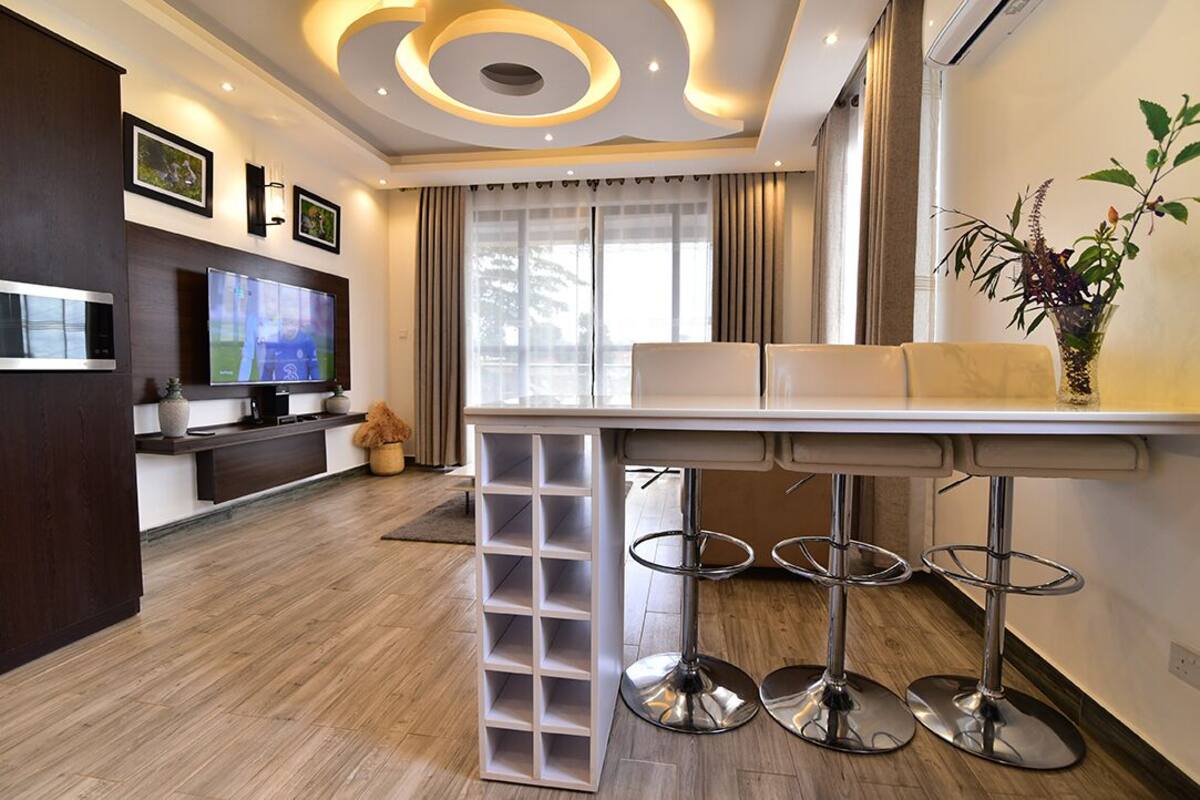 A modern kitchen with a built-in oven, a microwave, and a coffee machine.