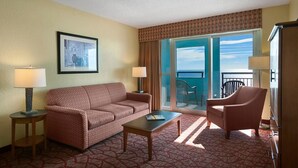A hotel room with a sofa, armchair, coffee table, and a large window with a view of the ocean. - Atlantic Paradise 2 Bedroom w/ Oceanfront Balcony (Myrtle Beach)