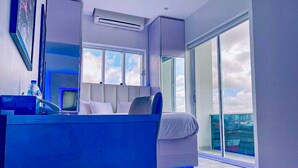 A modern bedroom with a bed, a desk, and a large window. - DREAMS BY DV8 (Lagos)