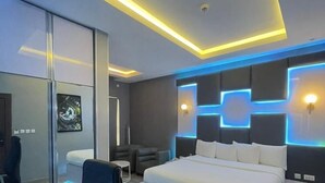 A modern bedroom with a large bed, a desk, and a chair. - DREAMS BY DV8 (Lagos)