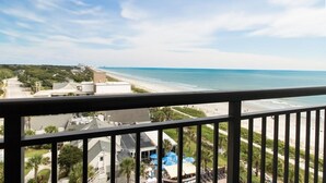 A view from a balcony overlooking a beach with a clear sky. - Newly Renovated Ocean View 3 Bdrm Condo 12th Flr (Myrtle Beach)