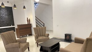 A modern living room with a sofa set, a coffee table, and a fireplace.