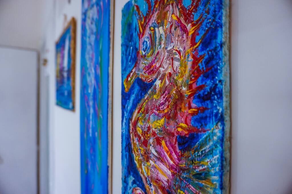 A series of colorful paintings on a wall.