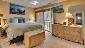 A bedroom with a bed, a dresser, a window, and a painting on the wall. - Livin' Lodge: 3  BR, 2  BA Townhouse in Carnelian Bay, Sleeps 8 (Carnelian Bay)