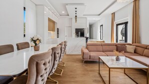 A modern living room with a dining area, featuring a marble-top table, plush seating, and a chandelier. - Villa Lukas with 4 bedrooms, a high-quality family property in the Makarska hinterland (Gornji Vinjani)