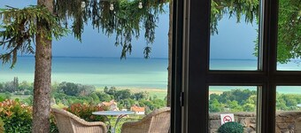 A charming country house with separate guest rooms overlooking the lake.