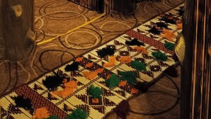A rustic interior with a wooden door marked '103', a patterned carpet, and a blue-lit wall. - Petra dad farm (Shamakh)
