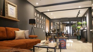 A modern living room with a sofa, coffee table, and framed pictures on the wall. - Dar Lala Mama (Marrakech)