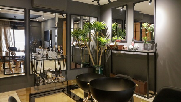 A modern dining area with a glass-top table, black chairs, and a decorative vase. - Dar Lala Mama (Marrakech)