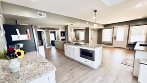 A spacious kitchen with a central island, white cabinetry, and a modern design. - *NEW -25ft to Beach, 2br. Oceanviews.Pool.Hot Tub (Corolla)
