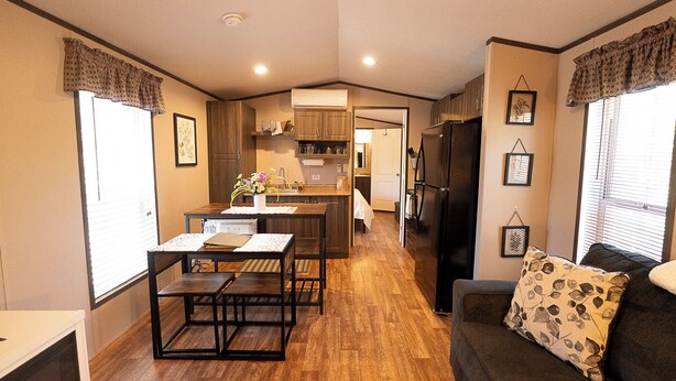 A compact living space with a kitchenette, dining area, and a sofa with a floral pillow. - Dog friendly peaceful retreat for 2 (Concho)