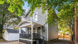 A two-story house with a covered porch and a small front yard. - Bill Murray - Private Barcade and Outdoor Lounge - OSU/Clintonville/CrewStadium (Columbus)