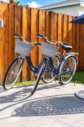 Two bicycles parked against a wooden fence. - Family Fun Villa | Heated Pool | Arcade & Ping Pong | BBQ | Near Hollywood Beach (Hollywood)