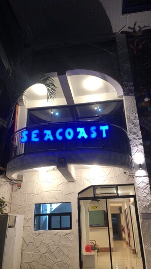 A building with a 'SEACOAST' illuminated sign, a stone facade, and a balcony. - Seacoast Hotel and Resort (Lapu-Lapu)