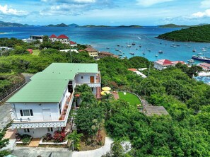 Situated amidst lush greenery, this coastal property offers a tranquil waterfront setting with a marina and rolling hills.