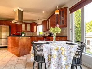 Enjoy meals in this kitchen with a central island, oven, and dining table.