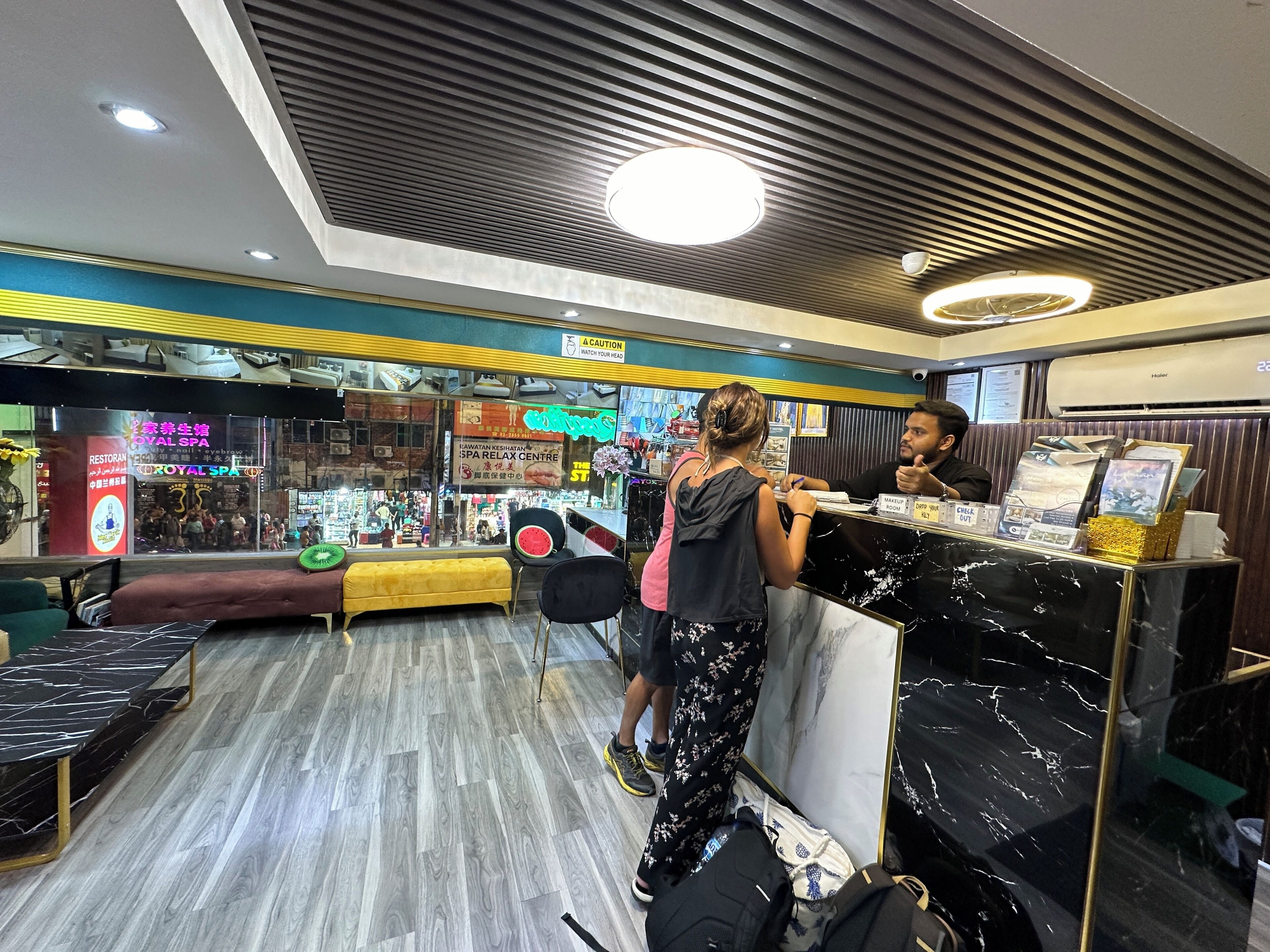 A spa and restaurant interior with a reception desk, seating area, and various amenities.