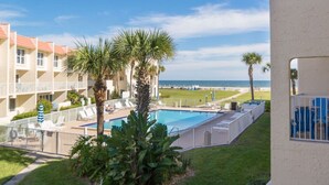 A hotel with a pool, palm trees, and a view of the beach. - Center of Saint Augustine Beach (St. Augustine)