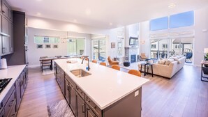 A modern kitchen with a large island, built-in appliances, and ample natural light.