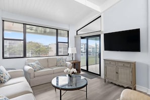 A modern living room with a sofa, coffee table, and TV.