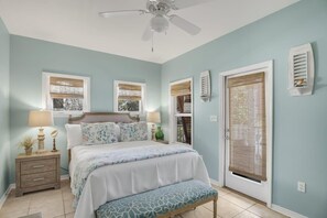A bedroom with a bed, bedside tables, a ceiling fan, and a window with blinds. - Golf Cart and 4 Bikes! Walk and Bike to the Beach or Gulf Place! Access 2 Pools! ~ Pineapple Under the Sea on 30A (Santa Rosa Beach)