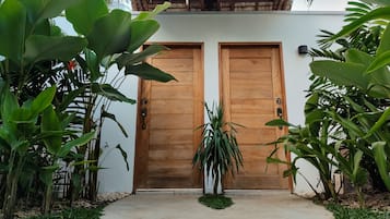 Enter a serene oasis surrounded by lush greenery and tropical plants.
