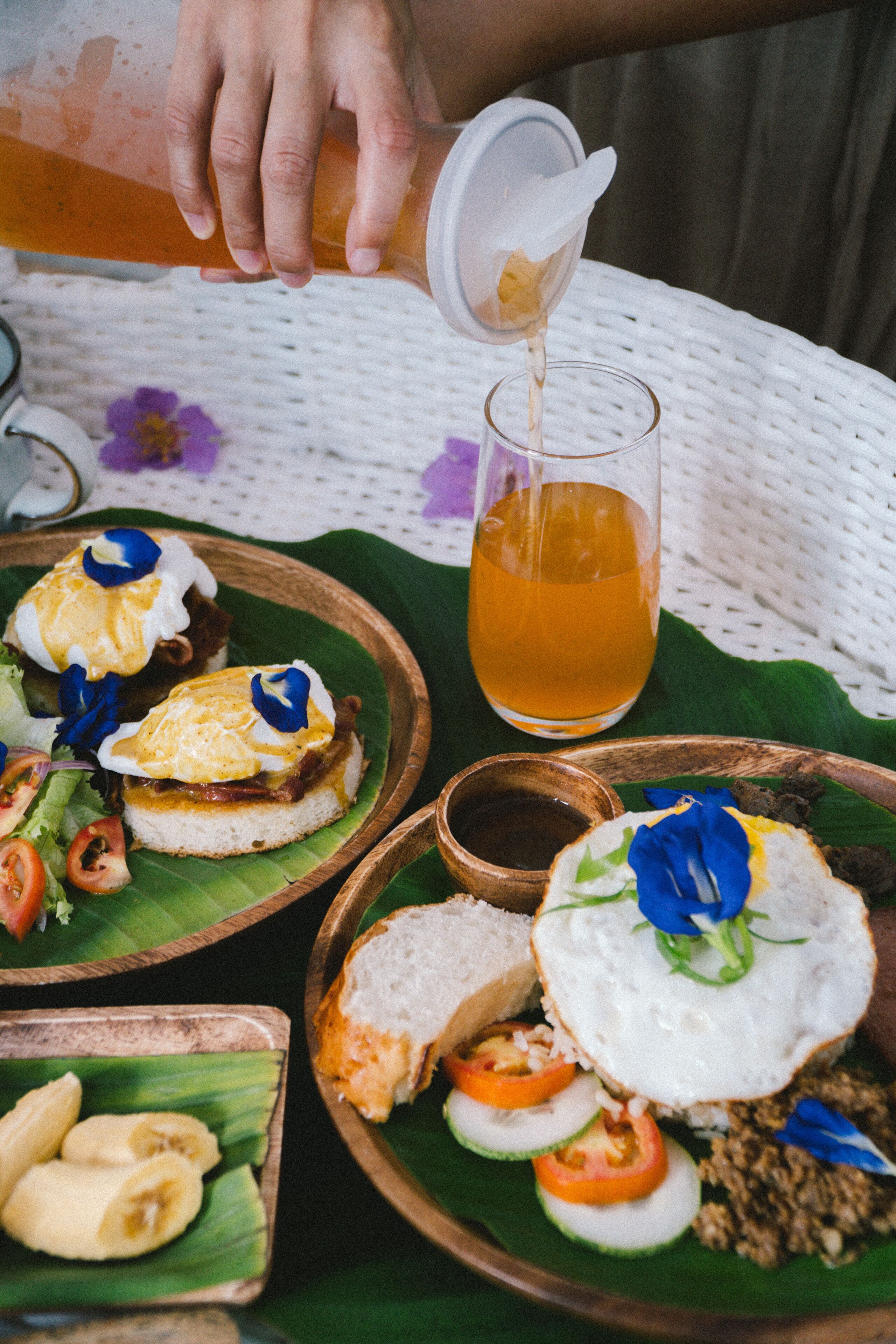 A table with food items and a glass of tea.