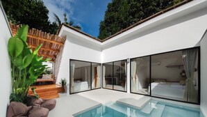 A modern house with a swimming pool, large glass doors, and a wooden deck. - Bahala Na Villas (El Nido)