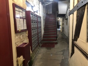 Staircase leads to a spacious area beyond.