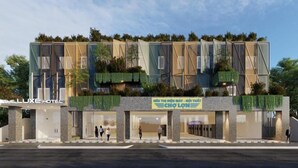 A modern hotel with a glass facade, green rooftop gardens, and a sign for 'CHO LOIN'. - The Luxe Hotel - Chau Doc (Chau Doc)